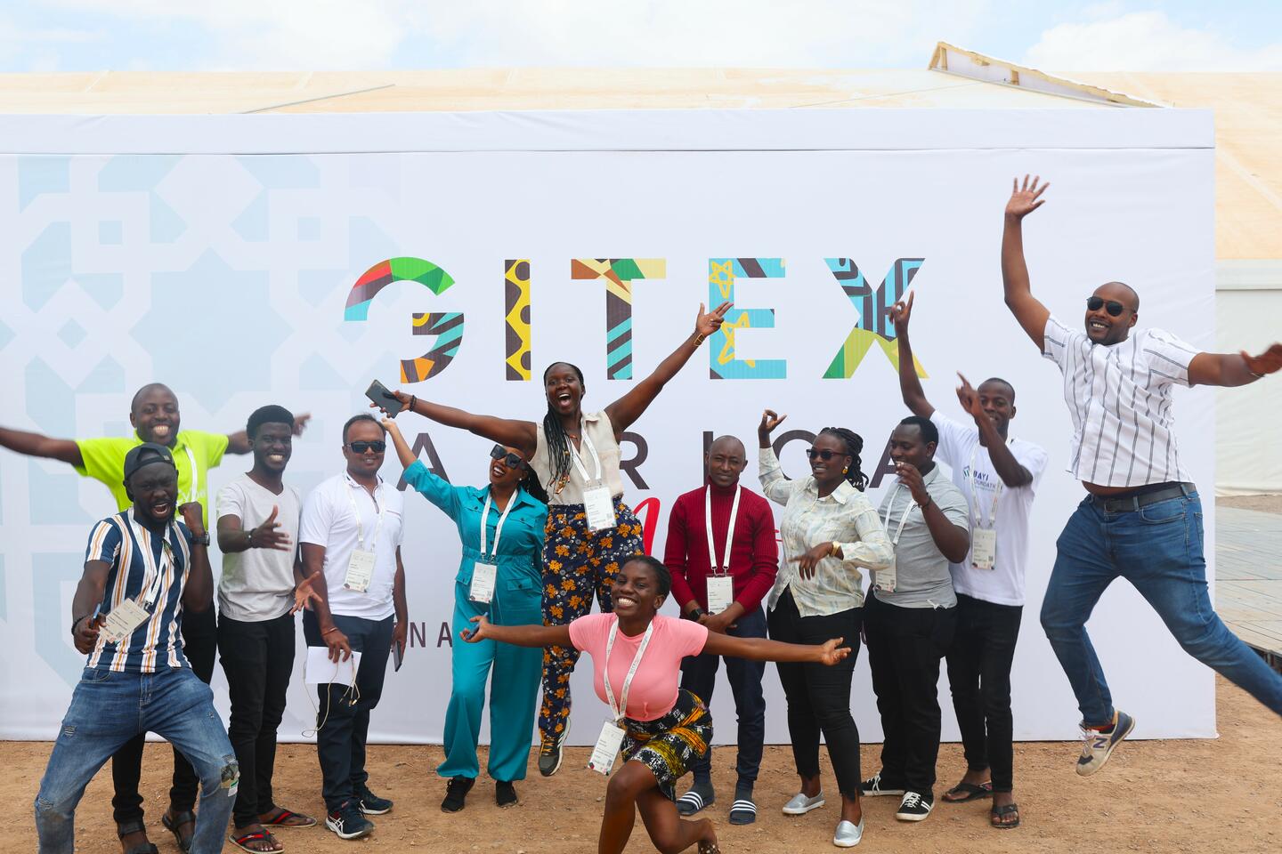 Group of entrepreneurs pose in front of GITEX Africa sign