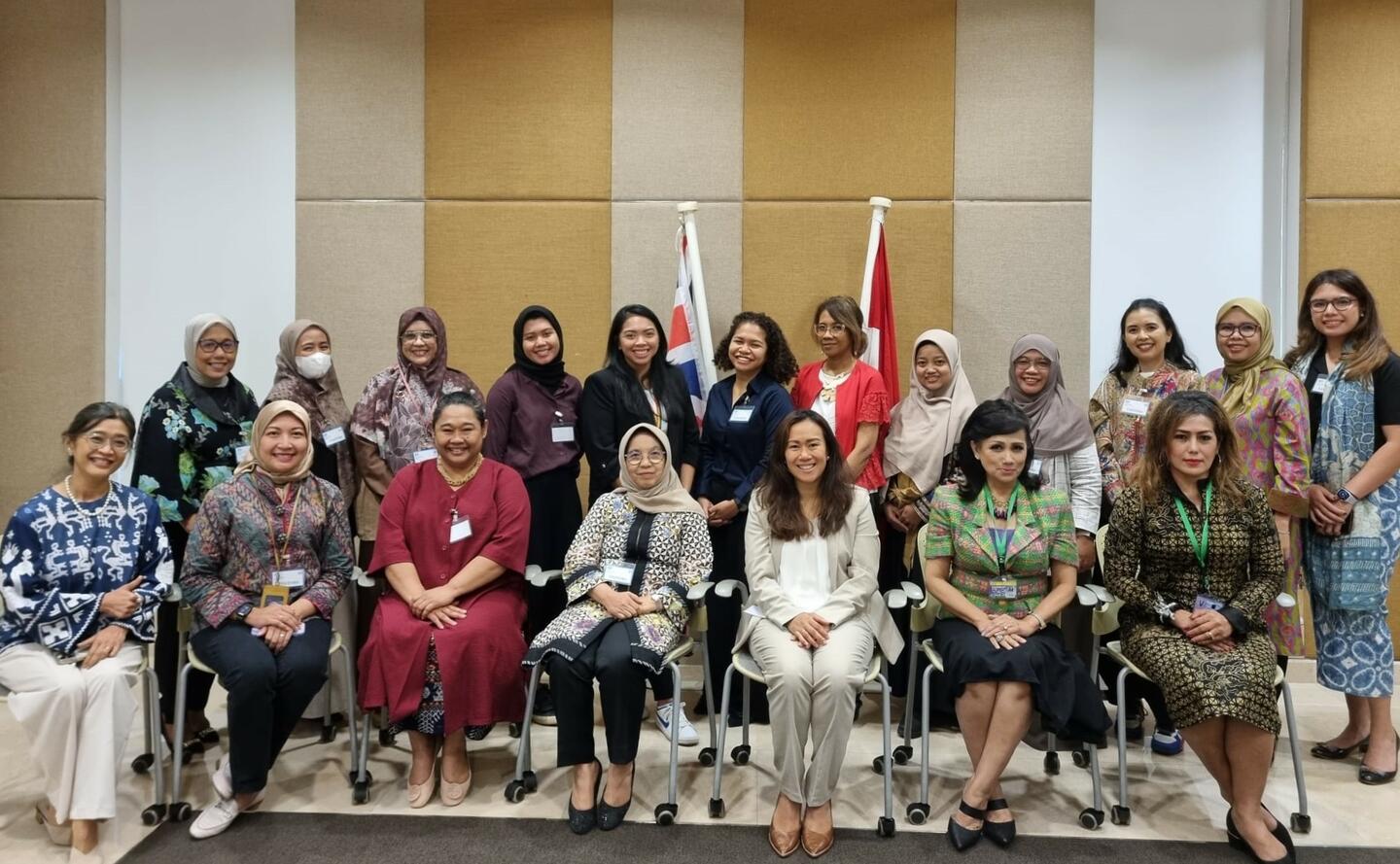 Group of Indonesian businesswomen pose in conference room