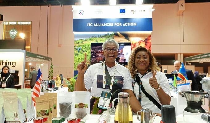 Two African women display their coffee products at trade show